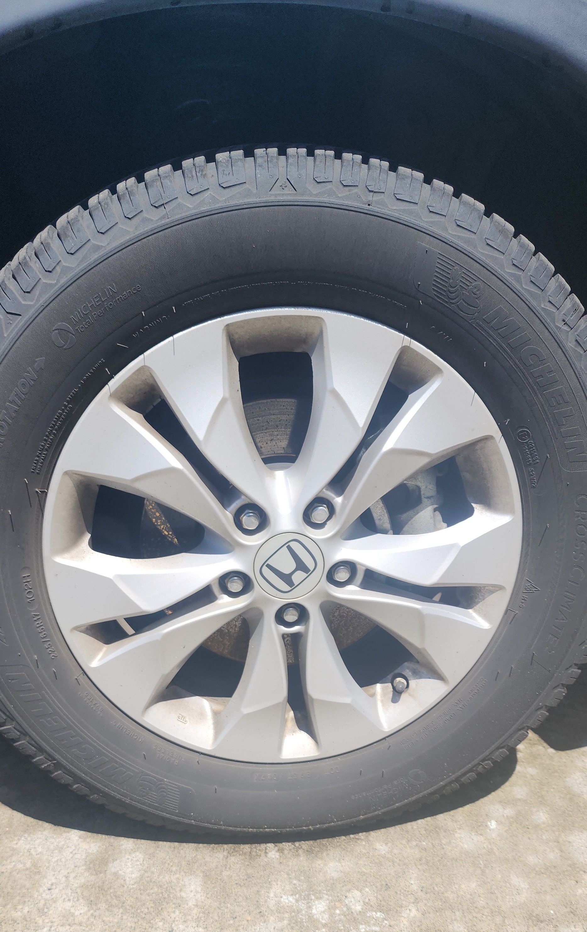 A close up of a honda wheel with a tire on it.