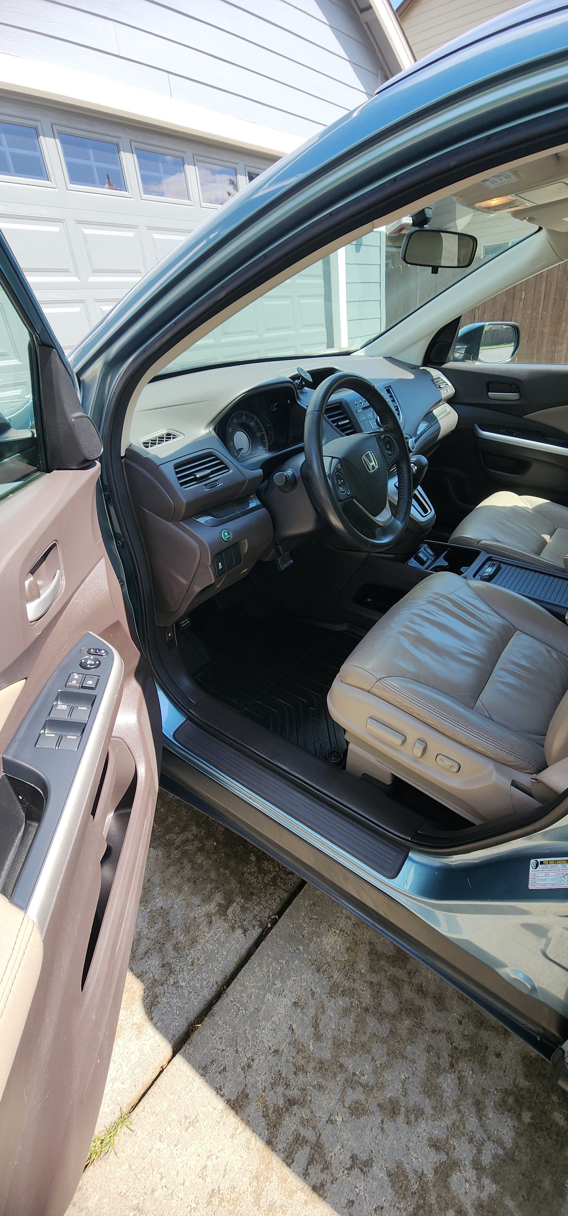 The interior of a car is shown with the door open.