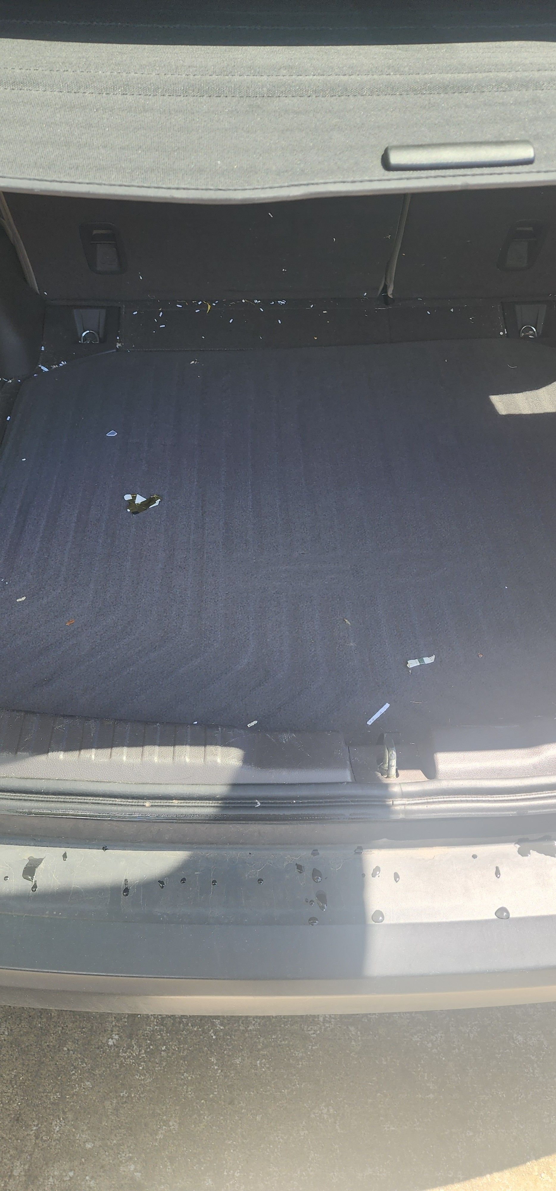 A close up of the back of a car with the trunk open.