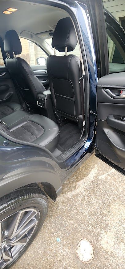 The inside of a blue car with the door open.