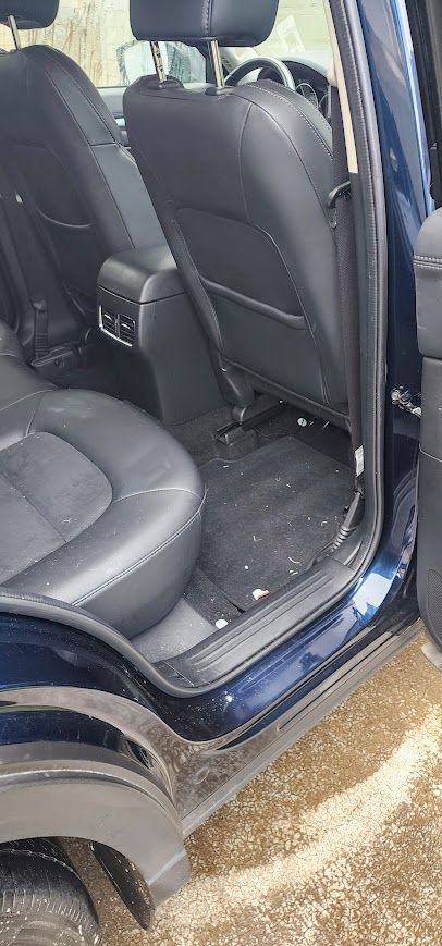 The inside of a blue car with the door open.