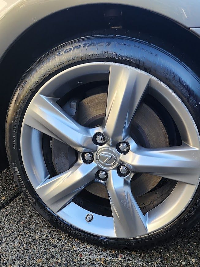 A close up of a car wheel with a tire on it.