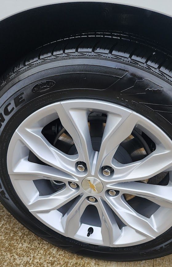 A close up of a car wheel with a tire on it.