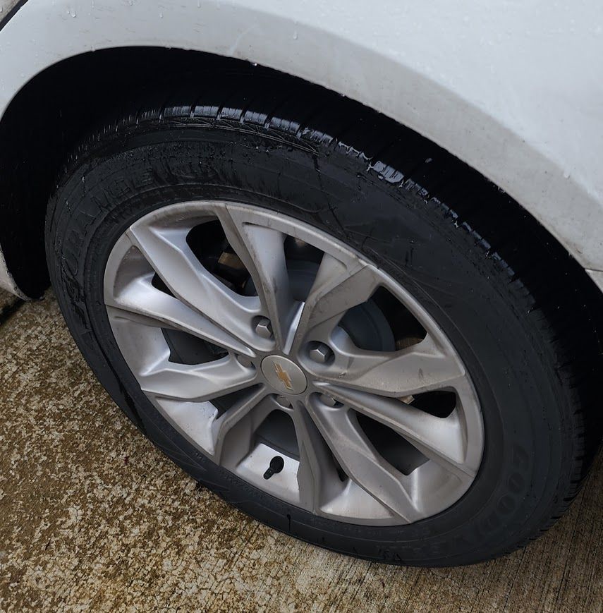 A close up of a tire on a white car