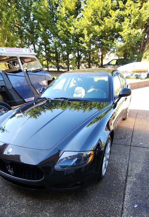 A black sports car is parked on the side of the road.