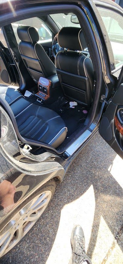 The inside of a car with the door open and a person standing next to it.