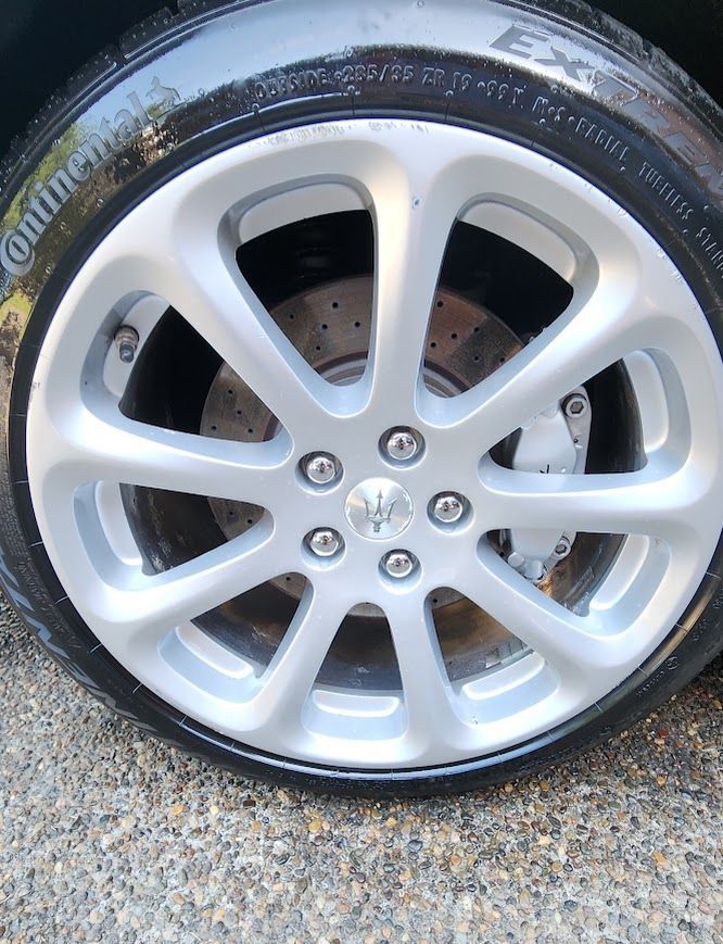 A close up of a car wheel with continental tires