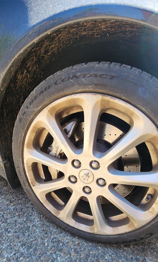 A close up of a car wheel with a tire on it.