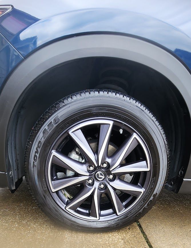 A close up of a car wheel with a tire on it.