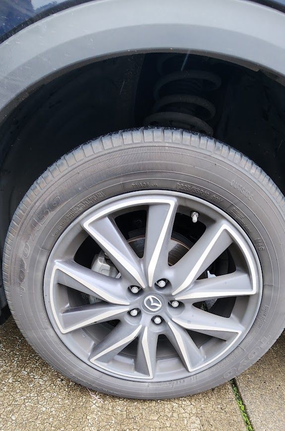 A close up of a car wheel with a tire on it.