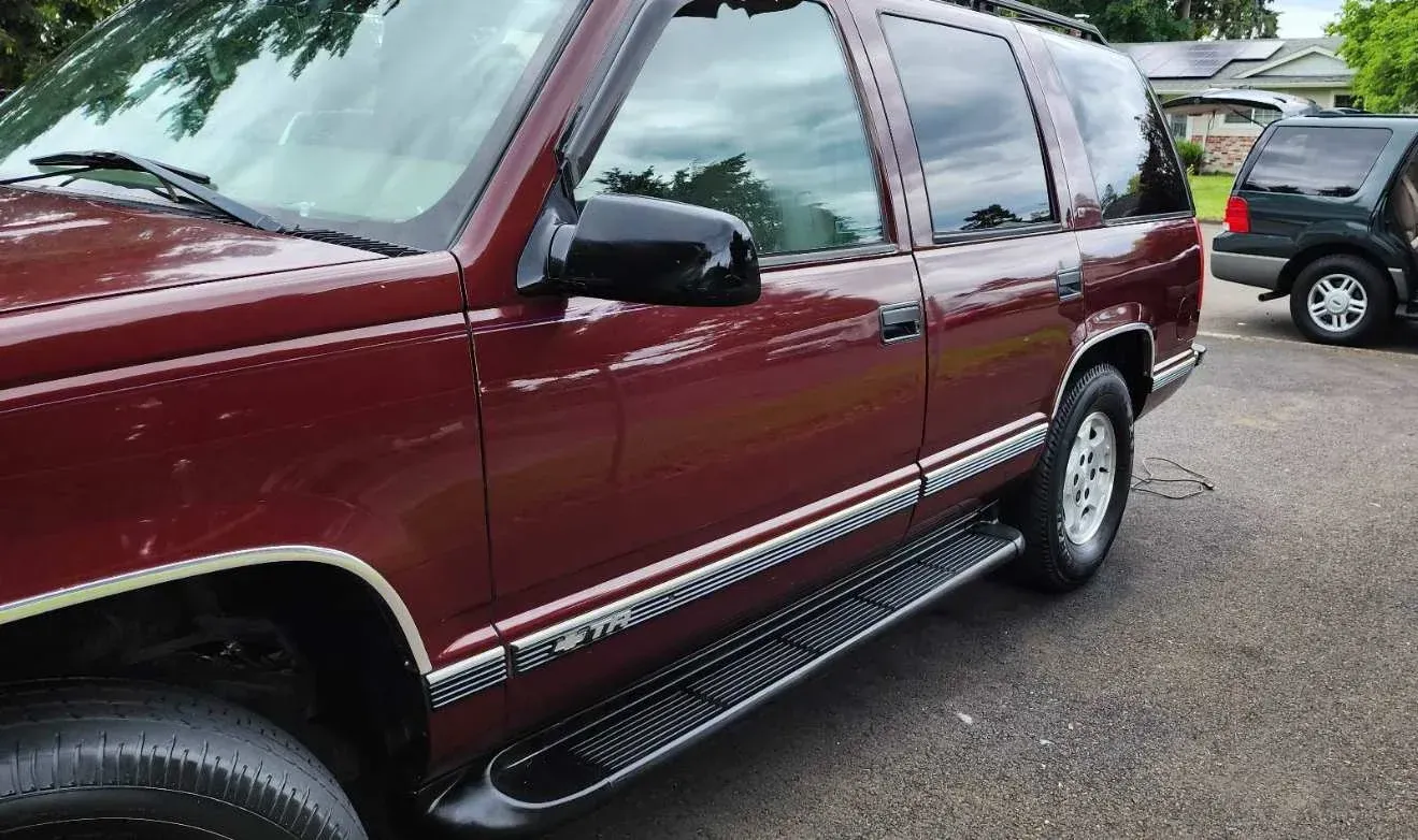 A red suv is parked in a parking lot.
