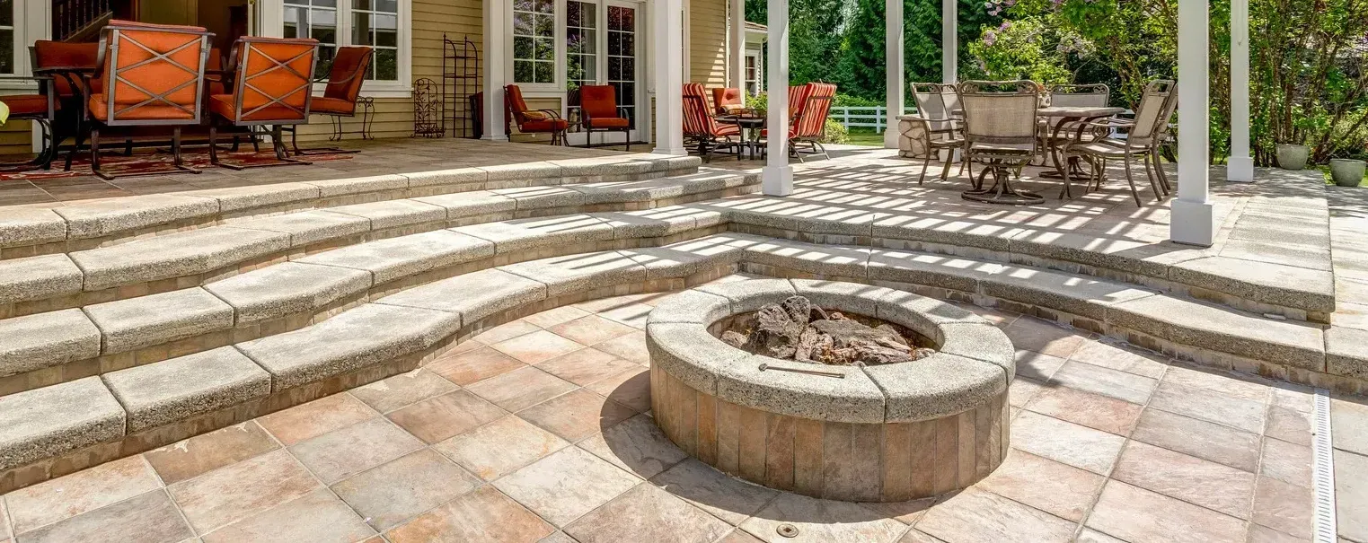 There is a fire pit in the middle of the patio.