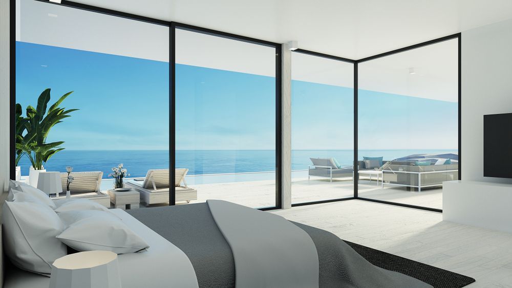 Beach house with windows overlooking the ocean — Loretta Davison Financial Solutions In Shellharbour, NSW 