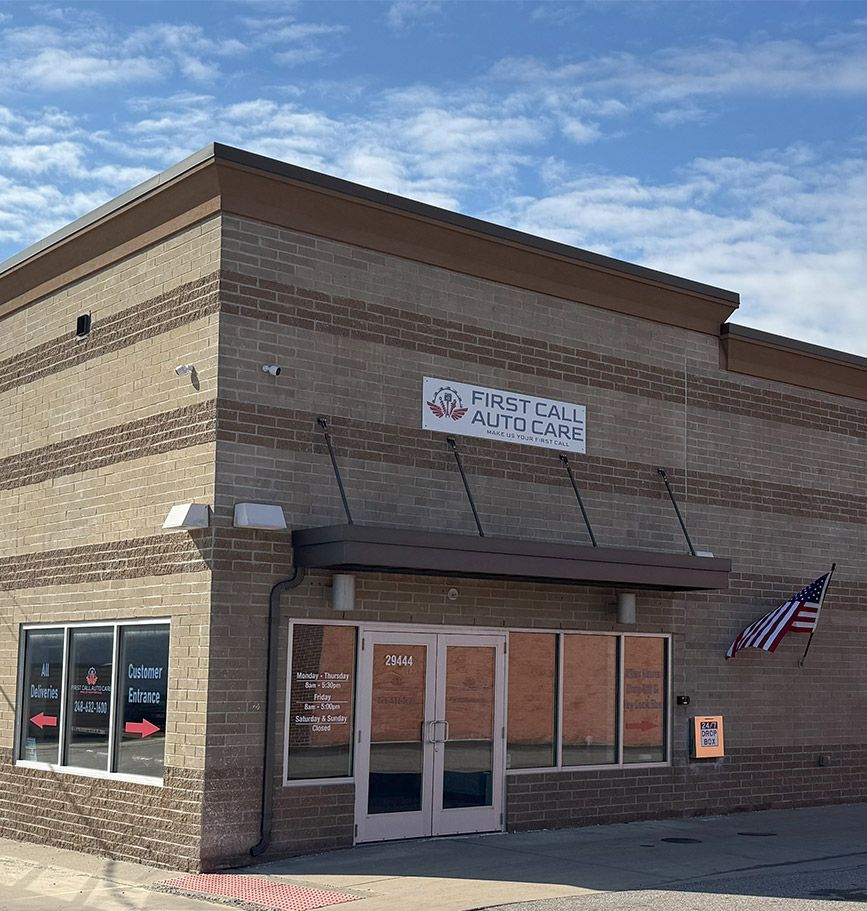 Exterior of First Call Urgent Care building with brick facade, awning, and American flag.