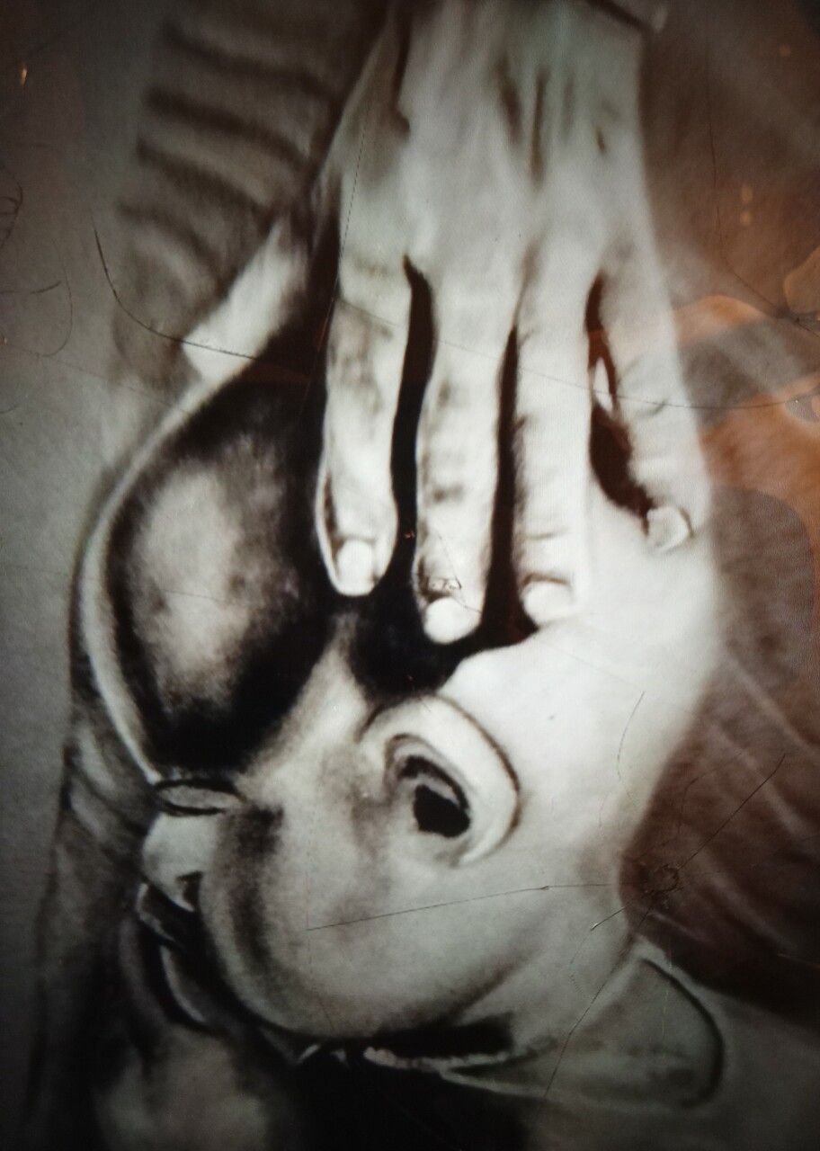 Painting of grandmother's hands on infant's head