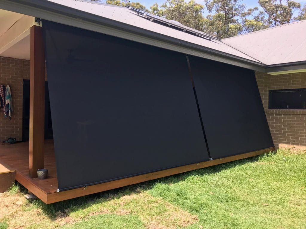 A House with A Black Awning on The Side of It — Winning Blinds in Cardiff, NSW