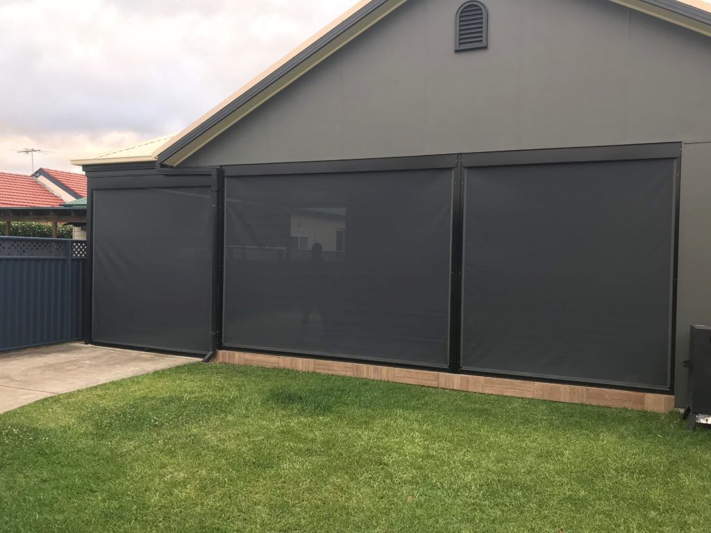 A House with A Fence and Blinds on The Side of It — Winning Blinds in Beresfield, NSW