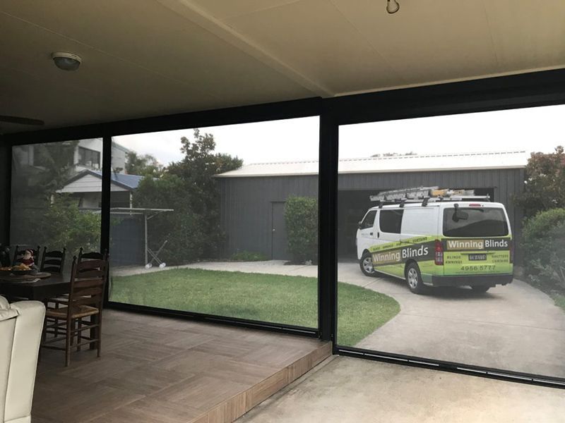 Exterior View With Black-framed Blinds, Overlooking A Lawn — Winning Blinds in Cardiff, NSW
