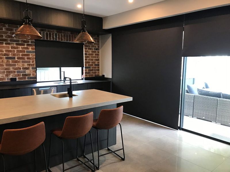 Kitchen With A Dark Countertop, Brick Wall, And Black Blinds — Winning Blinds in Cardiff, NSW
