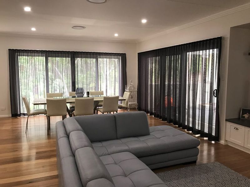 Living Room With Sectional Sofa, And Sheer Gray Curtains — Winning Blinds in Cardiff, NSW