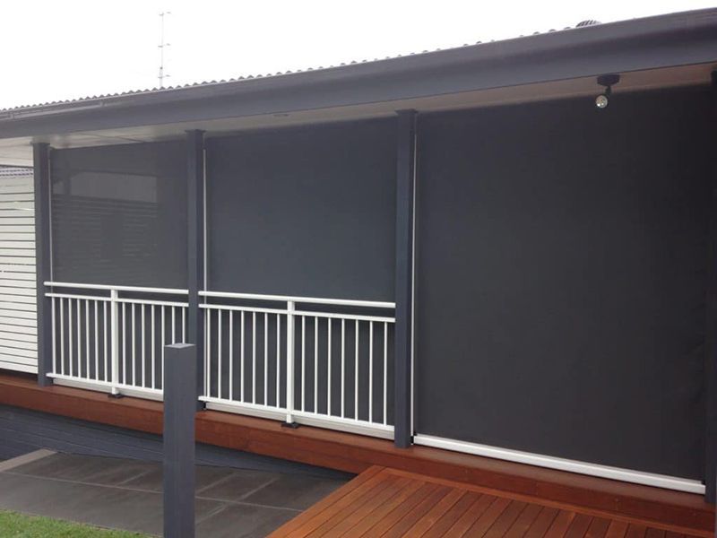 Outdoor Space With Gray Sun Blinds, Railing, And Wooden Deck — Winning Blinds in Cardiff, NSW