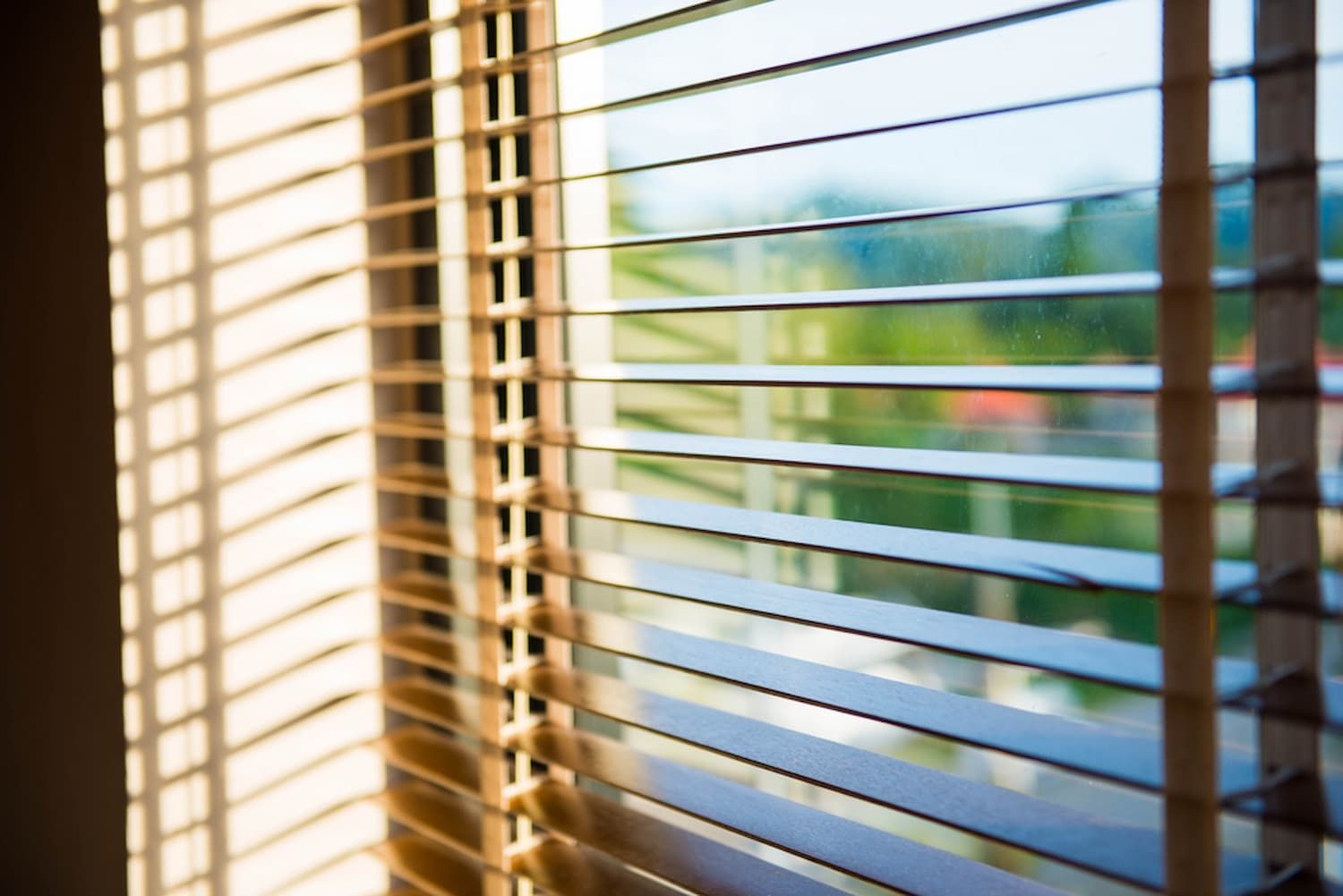 A Close-up Of a Window with Blinds on It — Winning Blinds in Cardiff, NSW