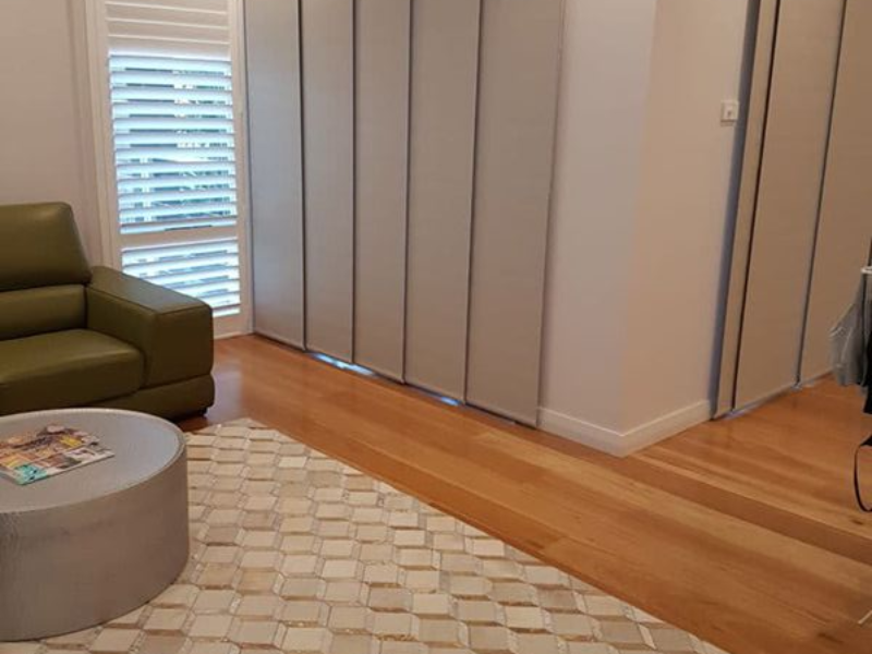 Tiled Floor And Wood Floor Area With Chair, And Window With Blinds — Winning Blinds in Cardiff, NSW