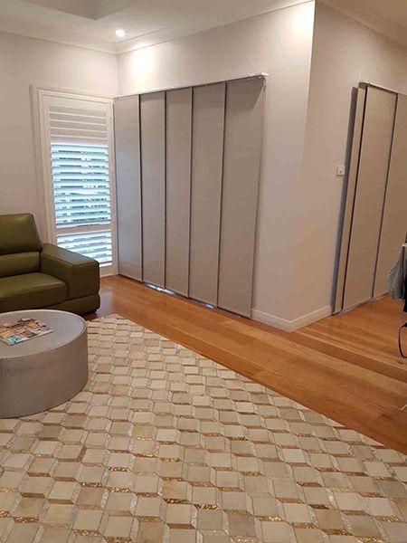 Living Room With Folding Panel Blinds, And Shuttered Window — Winning Blinds in Cardiff, NSW
