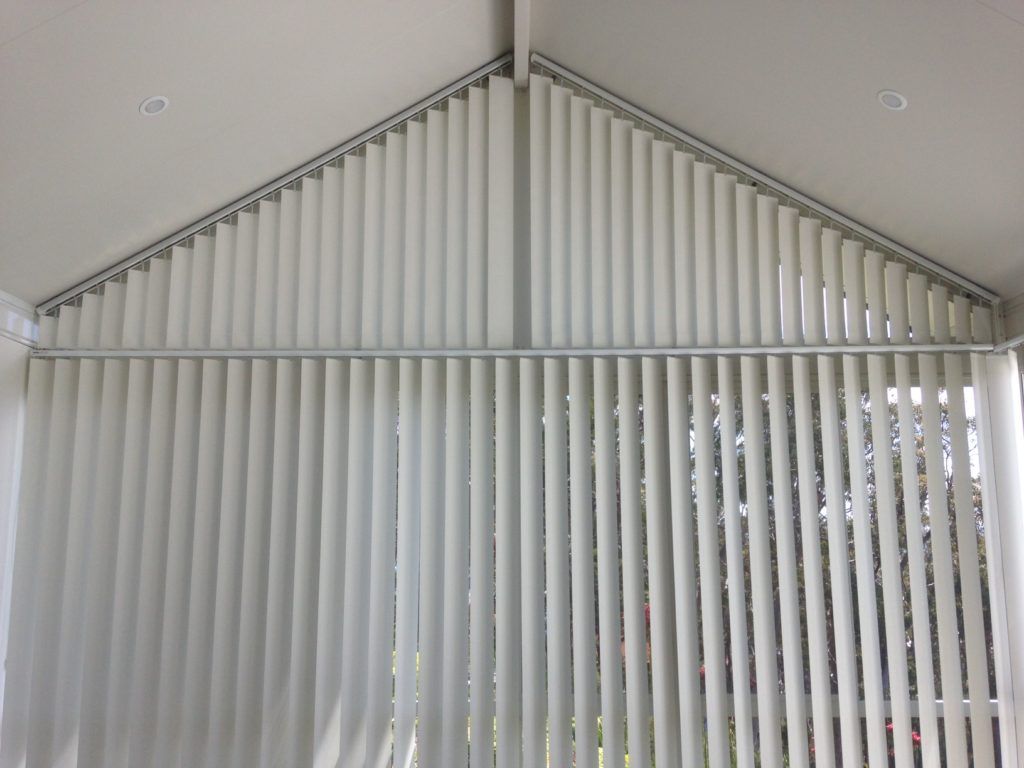 A Room with A Vaulted Ceiling and Vertical Blinds on The Windows — Winning Blinds in Maitland, NSW