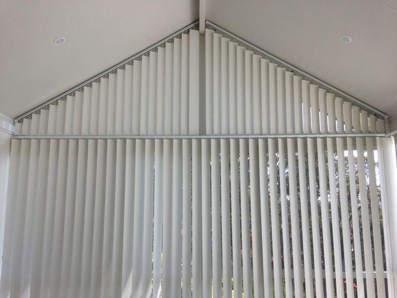 White Vertical Blinds Covering A Window In A Room — Winning Blinds in Cardiff, NSW