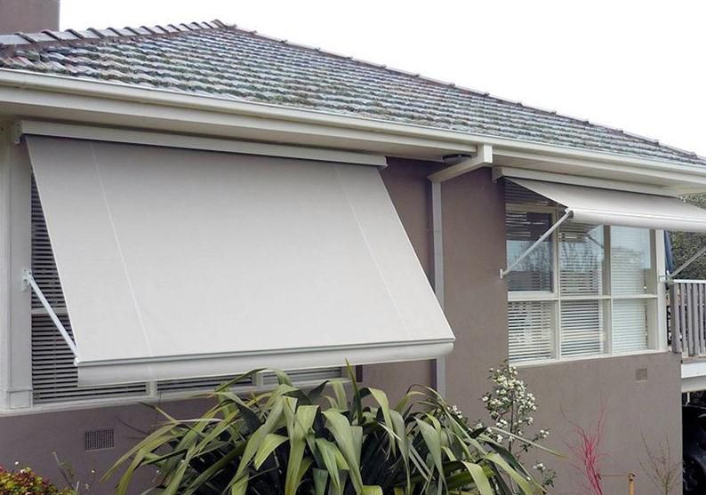 Exterior Of A House With Beige Awnings Over Windows — Winning Blinds in Cardiff, NSW