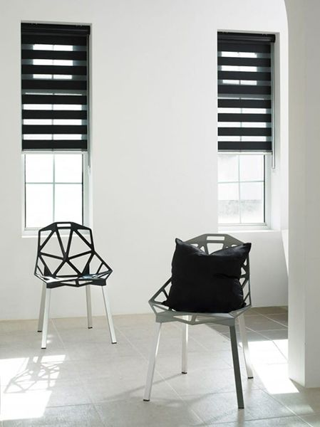 Two Modern Chairs And Black Blinds Partially Opened — Winning Blinds in Cardiff, NSW