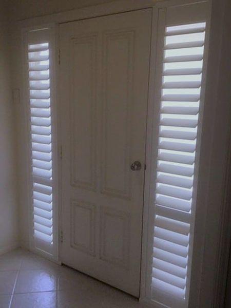 White Door With Matching Shutters On Either Side In A Hallway — Winning Blinds in Cardiff, NSW