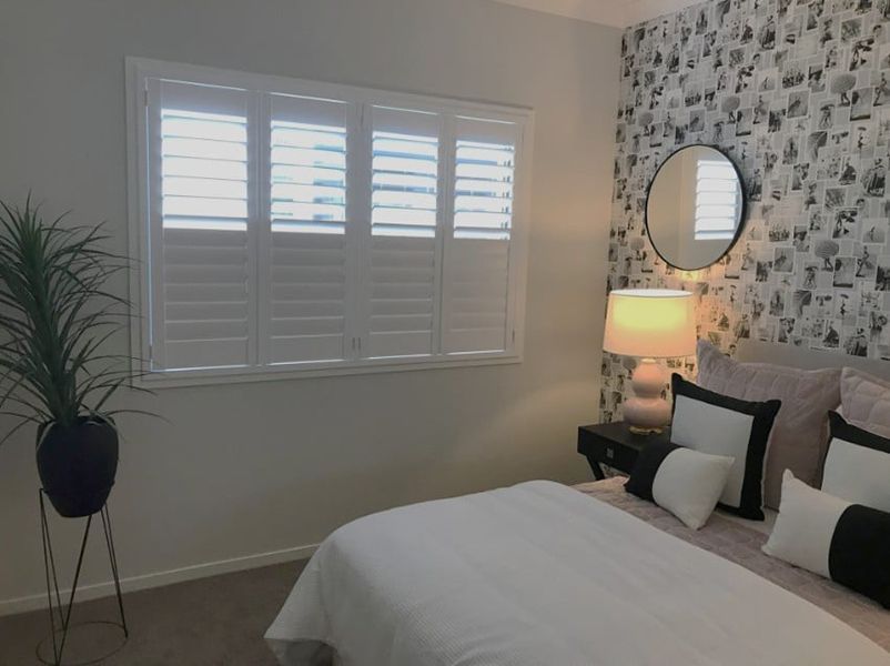 Bedroom With White Shutters, And Patterned Wallpaper — Winning Blinds in Cardiff, NSW