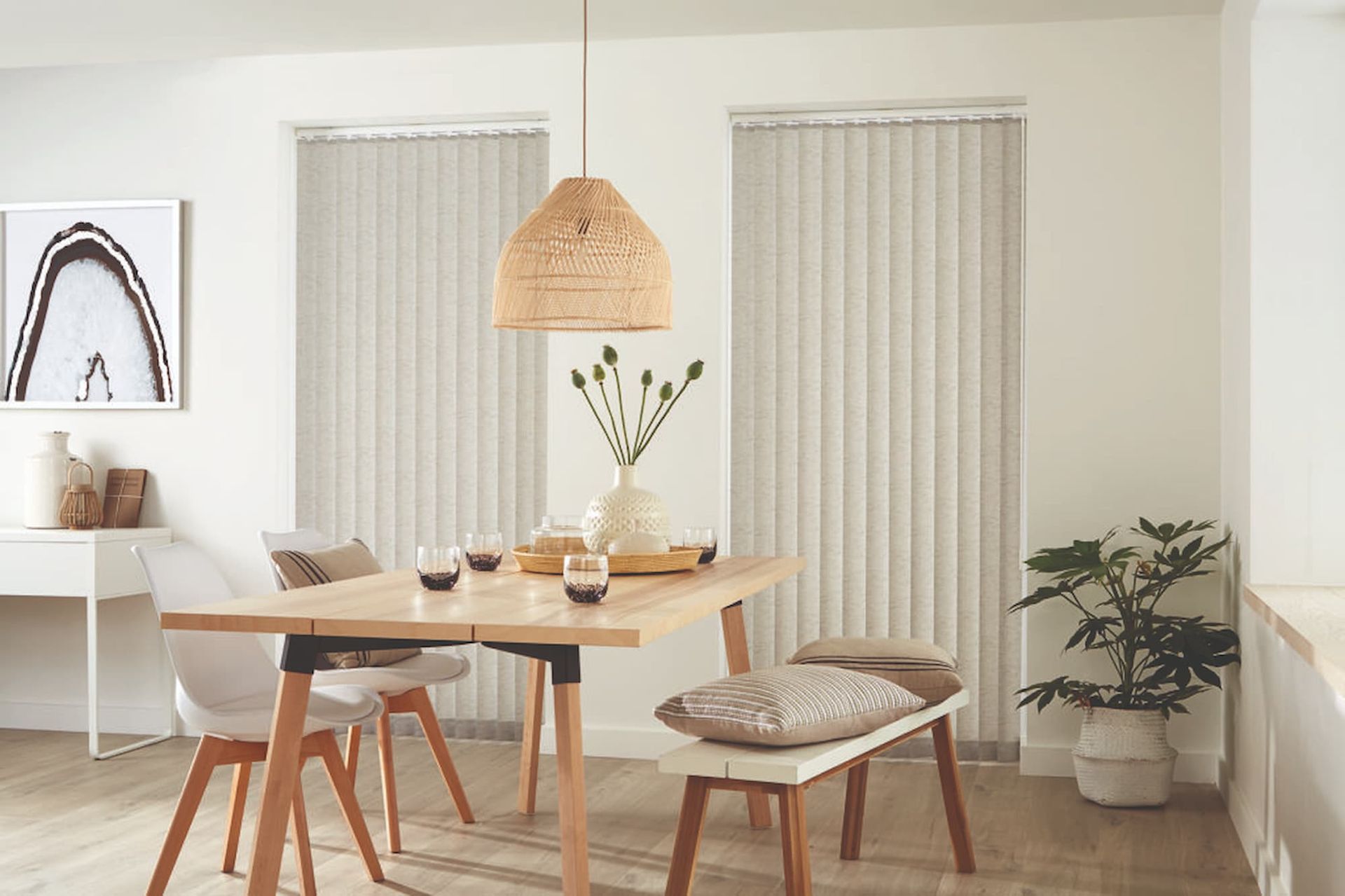 A Dining Room with A Table and Chairs and Vertical Blinds — Winning Blinds in Toronto, NSW