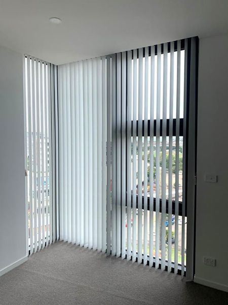 Vertical Blinds Covering Large Corner Windows, Letting In Daylight — Winning Blinds in Cardiff, NSW