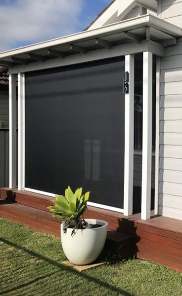 Outdoor Roller Blind On A Deck With White Trim, And A Potted Plant — Winning Blinds in Cardiff, NSW