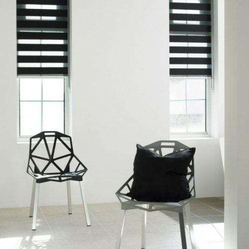 A Room With Two Chairs and Two Windows With Black Blinds — Winning Blinds in Cardiff, NSW