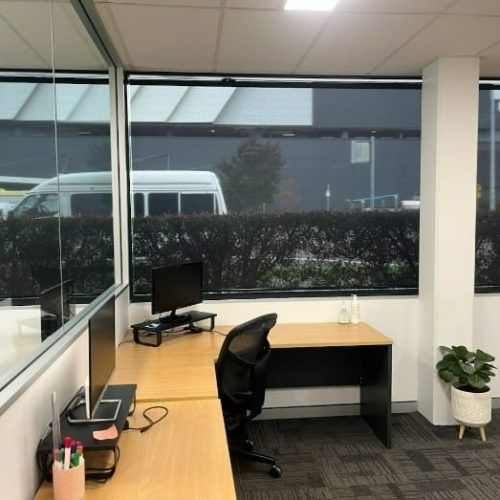 A Desk With a Computer and a Chair in an Office — Winning Blinds in Cardiff, NSW