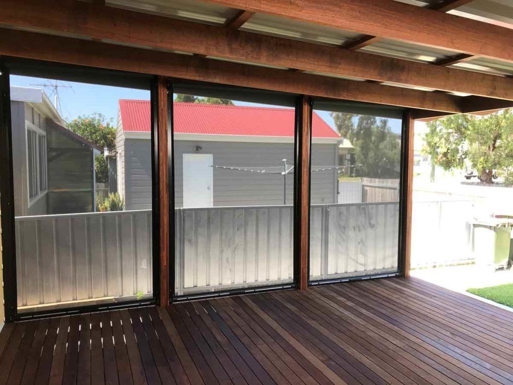 An Empty Deck with A Red Roof and A Fence in The Background — Winning Blinds in Maitland, NSW