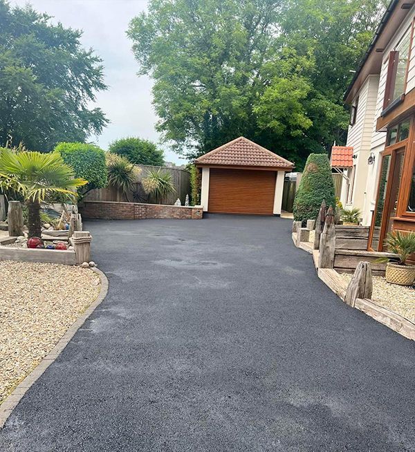 A driveway leading to a house with a garage.