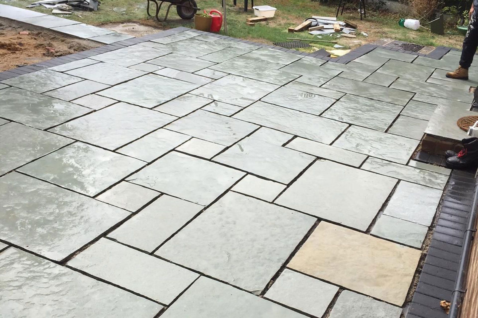 Patio laying in Woking by Surrey Hills, showcasing new paving and drainage.