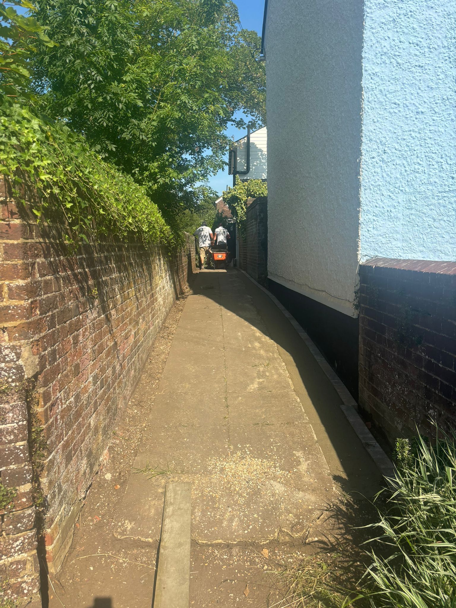 Narrow access path to a property in Woking, used by Surrey Hills for landscaping.