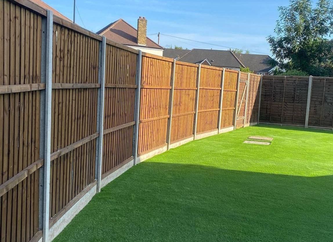 New wooden fence and artificial grass installed in Woking by Surrey Hills.