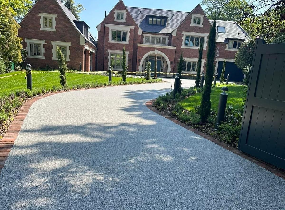 A large brick house with a driveway leading to it