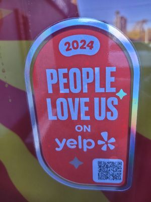 A sign that says people love us on yelp A sign that says people love us on yelp