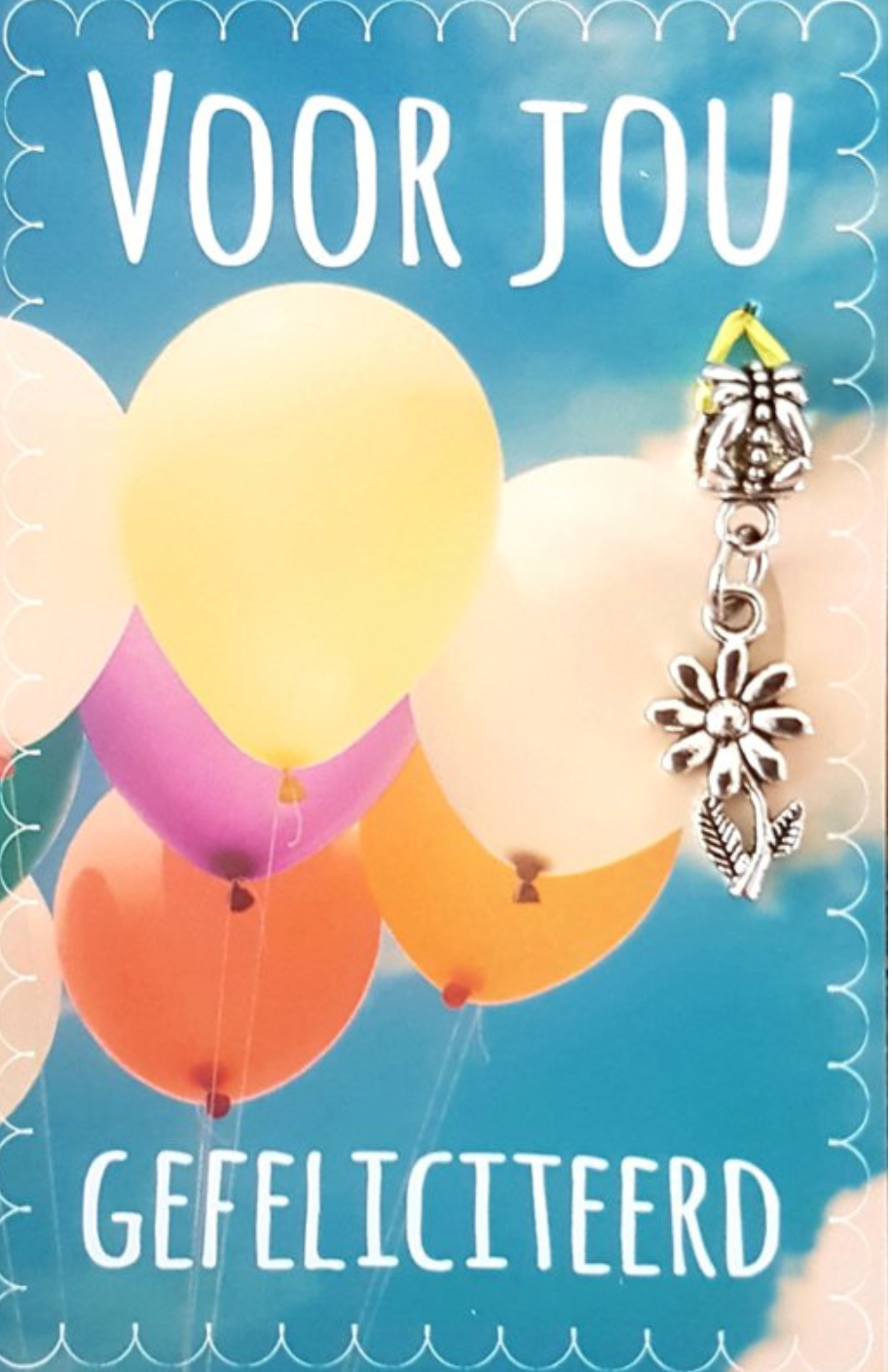 Card with balloons and attached charm. Text says