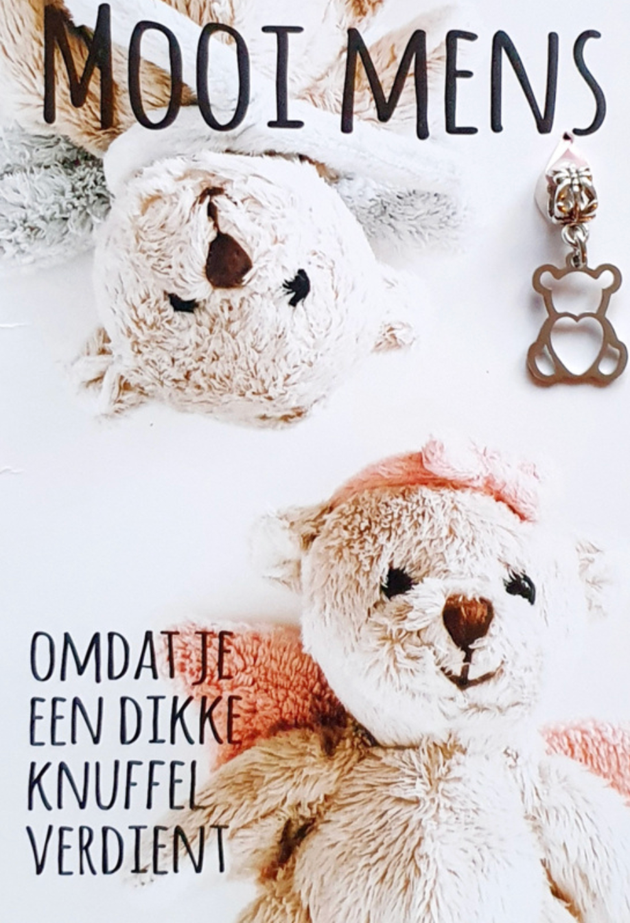 Two teddy bears and a charm on a white background, with text saying