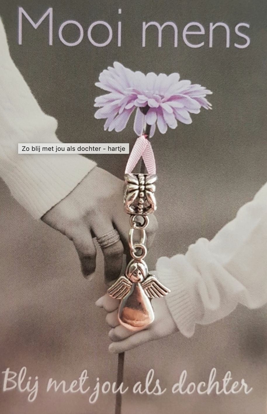 Person holding hands, charm with flower,