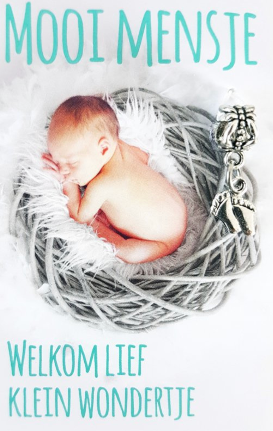 Newborn baby sleeping in a grey nest, with